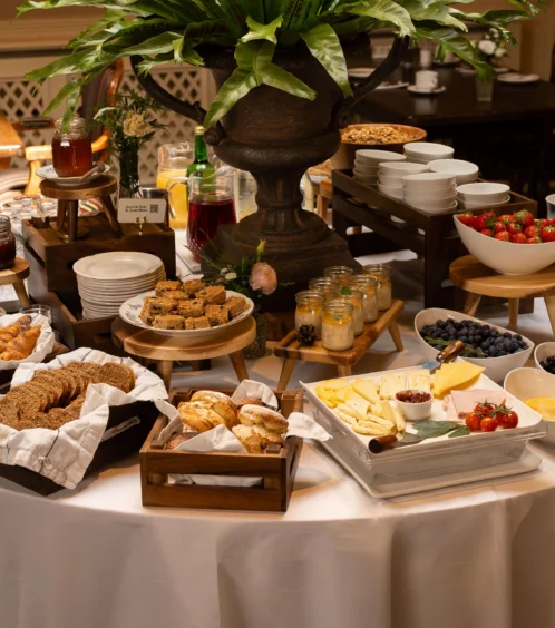 A welcoming breakfast buffet with pastries, fruits, and drinks at Fernhill House Hotel.