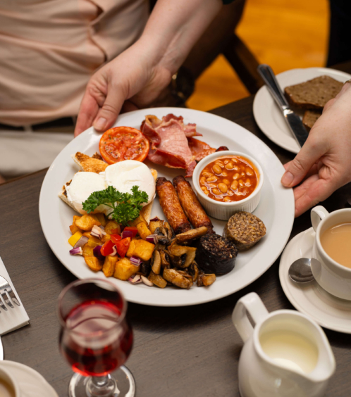 Family enjoying a hearty full English breakfast at Fernhill House Hotel.