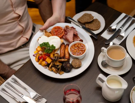 A family enjoys a hearty breakfast at Fernhill House Hotel's cosy dining area.