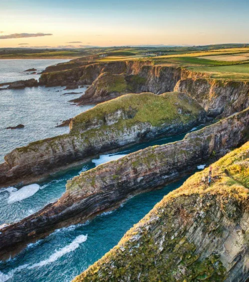 Family enjoying coastal views at Fernhill House Hotel, overlooking dramatic cliffs and ocean.