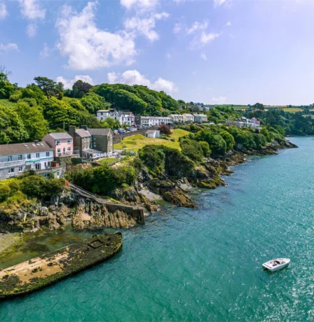 Coastal village view near Fernhill House Hotel with lush greenery and tranquil blue waters.
