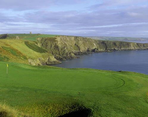Scenic coastal view with lush green golf course at Fernhill House Hotel.