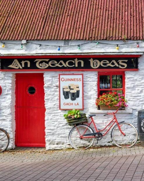 Cosy, rustic pub façade with vintage bicycles and floral decor.