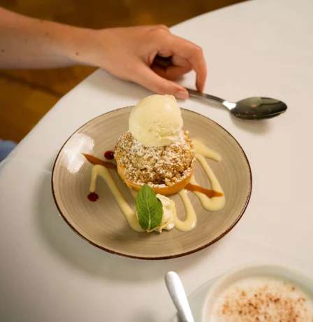 Elegant dessert with ice cream served at Fernhill House Hotel restaurant table.