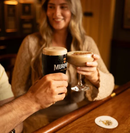 A couple enjoying drinks in a cosy Fernhill House Hotel bar.