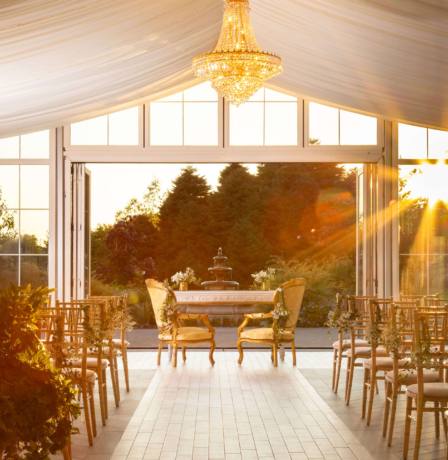 Elegant sunlit wedding venue set for a ceremony at Fernhill House Hotel.