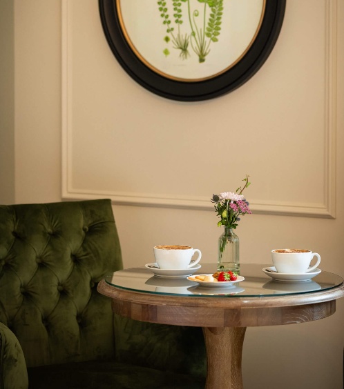 Cosy seating area with coffee and flowers at Fernhill House.