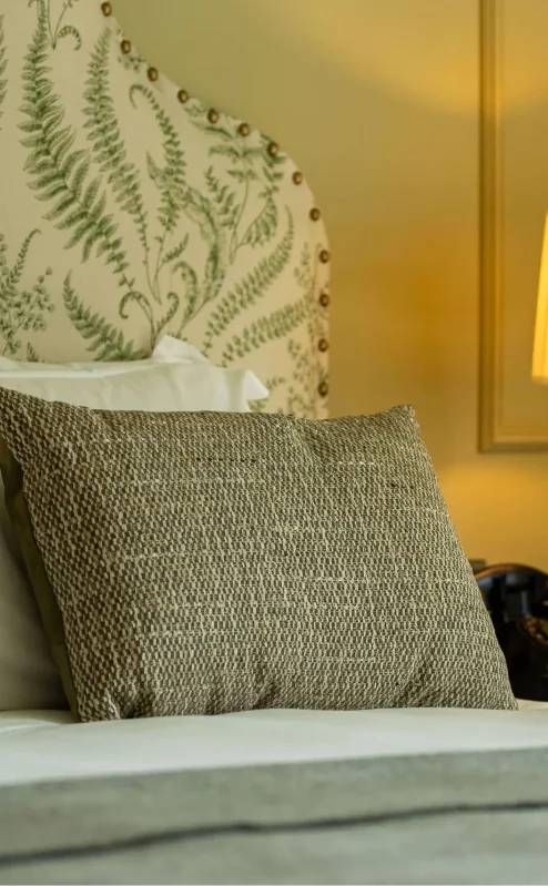 Cosy hotel bedroom with elegant décor, soft lighting, and a plush bed at Fernhill House Hotel.