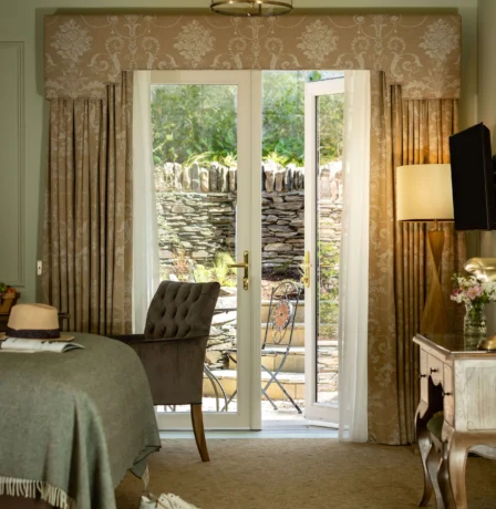 Cosy hotel room with garden view and inviting decor.