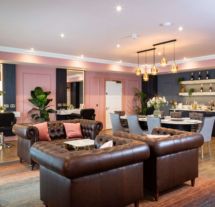 Family enjoying luxury lounge at Fernhill House Hotel with plush seating and elegant decor.