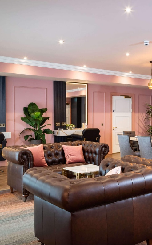 Family enjoying luxury lounge at Fernhill House Hotel with plush seating and elegant decor.