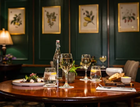 Cosy dining room with elegant table setting and wall art, perfect for a family meal.
