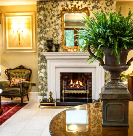 Elegant hotel lounge with a cosy fireplace and welcoming seating area.