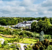 Aerial view of Fernhill House Hotel surrounded by lush gardens and countryside.