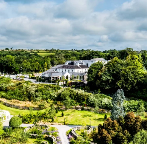 Aerial view of Fernhill House Hotel surrounded by lush gardens and countryside.