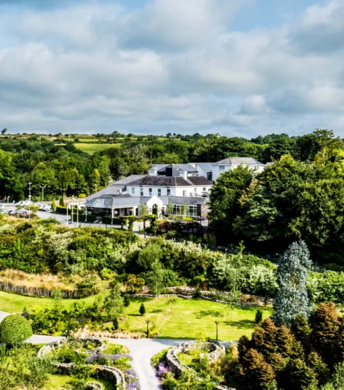 Aerial view of Fernhill House Hotel surrounded by lush gardens and countryside.