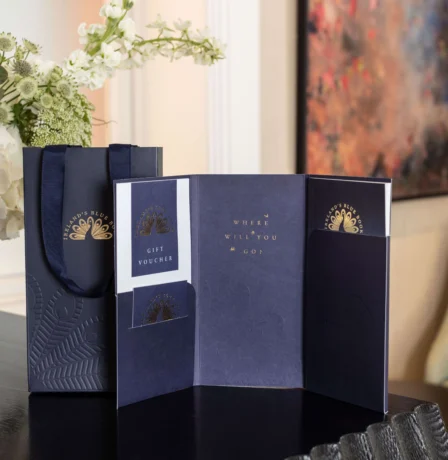 Elegant hotel gift vouchers on a table with floral decor.