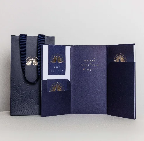Elegant gift voucher and bag from Fernhill House Hotel on a white table.