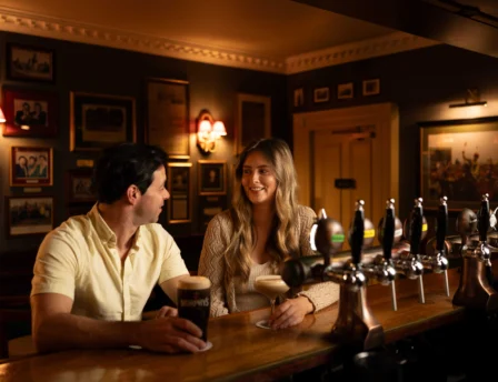 Couple enjoying drinks at Fernhill House Hotel's cosy bar.