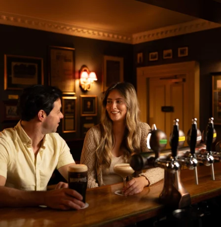 Couple enjoying drinks at Fernhill House Hotel's cosy bar.
