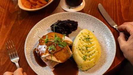 Cosy dining with hearty meal and stout at Fernhill House Hotel.