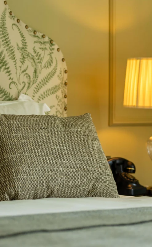 Cosy hotel room with elegant decor and warm lighting.